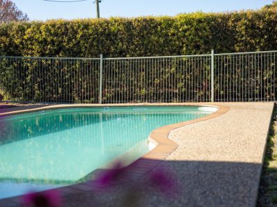An inground swimming pool with light blue water